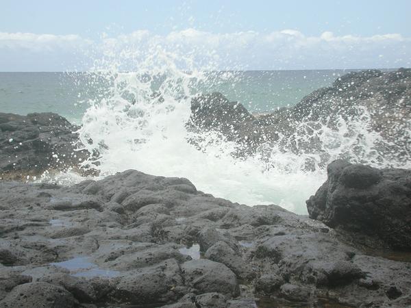 Waves crashing onto the lava