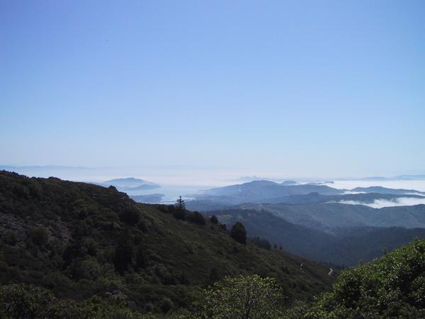 The fog washing onto the hills, the city far away